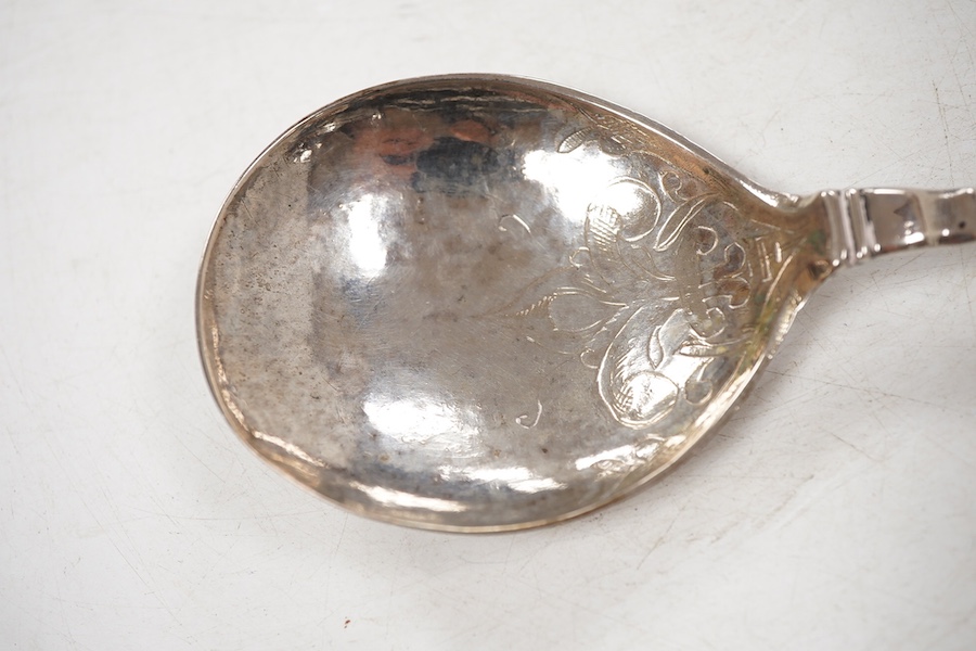 A late 18th/early 19th century Swedish? white metal spoon, with pierced parcel gilt finial, indistinct marks on the stem, 15cm.